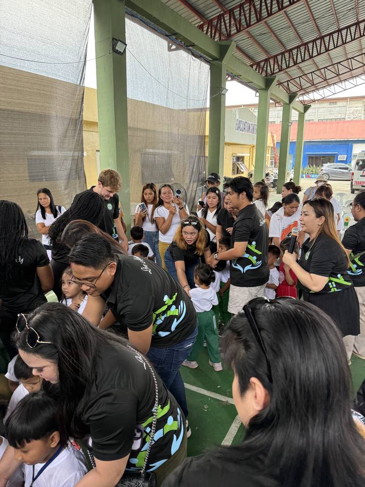 Families and the MRD team gathered at the covered court on distribution day